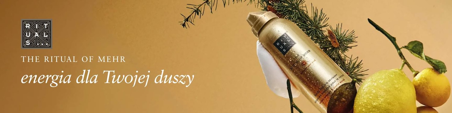 Złota butelka balsamu do ciała Ritual of Mehr, otoczona gałązkami i cytrynami, obiecuje energię dla Twojej duszy.